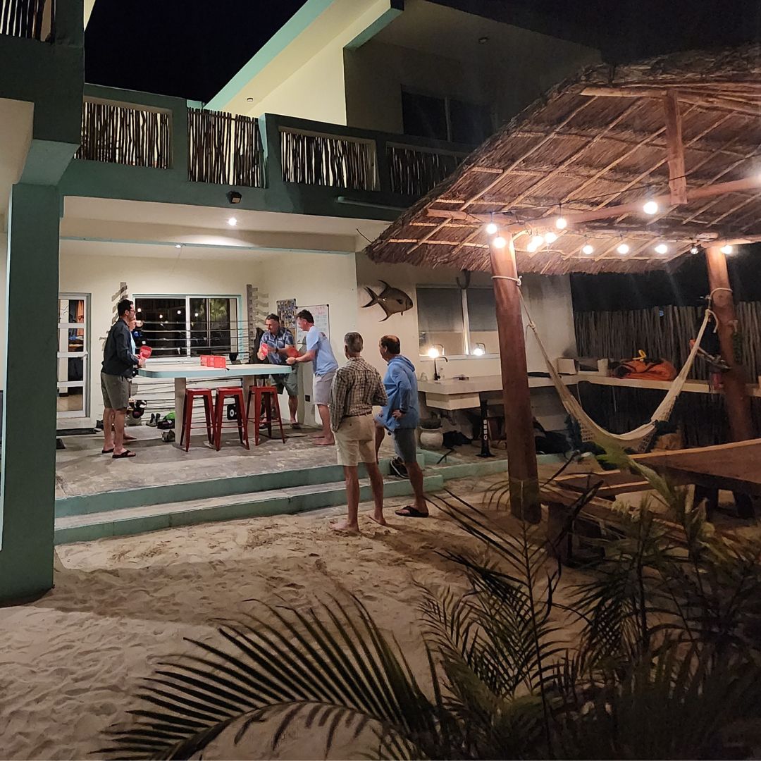 men playing pepper pong during getaway to beach