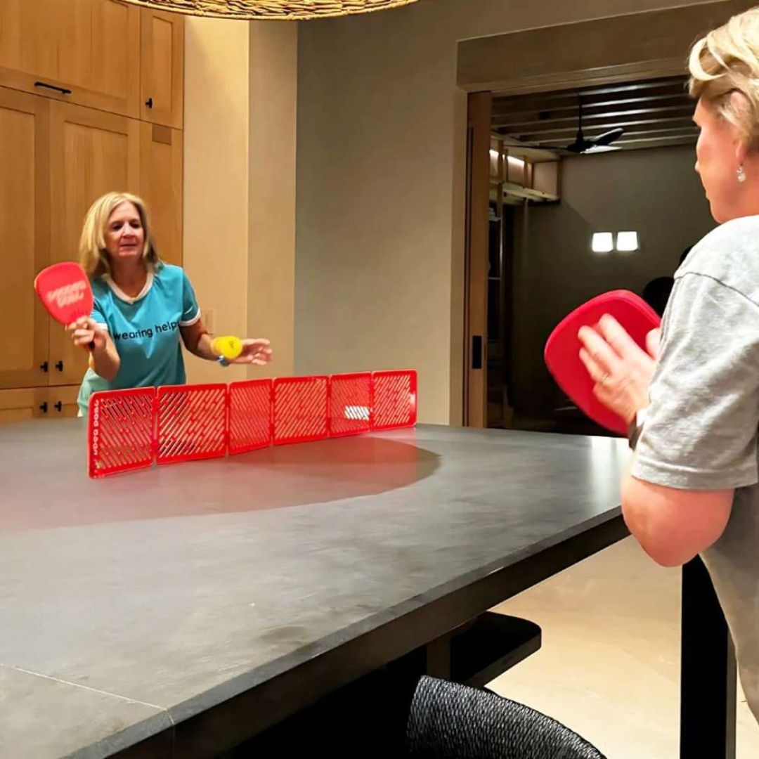 moms play pepper pong during girls weekend away