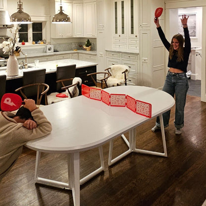 teenagers playing pepper pong in kitchen